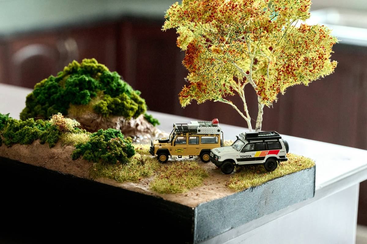 Mega G slot cars racing on custom plywood track with brass rails